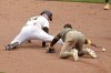 Pittsburgh Pirates' Joey Bart, left, slides safely into second with a double as the ball gets away from San Diego Padres second baseman Luis Arraez, right, during the ninth inning of a baseball game in Pittsburgh, Thursday, Aug. 8, 2024. (AP Photo/Gene J. Puskar)
