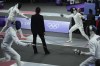 A referee observes as players compete in the men's individual fencing portion of Modern Pentathlon Summer Olympics at the 2024 Summer Olympics, Thursday, Aug. 8, 2024, in Villepinte, France. (AP Photo/Mosa'ab Elshamy)