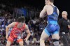 Japan's Rei Higuchi, in red, and Spencer Richard Lee, of the United State, compete in their men's freestyle 57kg final wrestling match, at Champ-de-Mars Arena, during the 2024 Summer Olympics, Friday, Aug. 9, 2024, in Paris, France. (AP Photo/Eugene Hoshiko)