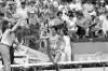 FILE - Twenty-seven-year-old Joan Benoit of Freeport, Maine, waves the American flag enthusiastically on Aug. 5, 1984, in Los Angeles after finishing the first-ever Olympic women's marathon in the fastest-ever time for that distance. 2.24:52 for the 26-mile, 385-yard course. (AP Photo/Dieter Endlicher, File)
