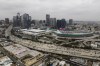FILE - This aerial view shows traffic moving along the 110 Freeway past the Los Angeles Convention Center in Los Angeles, Tuesday, Sept. 5, 2023. As the Olympics close in Paris, Los Angeles will take the torch. The city will become the third city to host the games three times as it adds 2028 to the locally legendary years of 1932 and 1984. (AP Photo/Jae C. Hong, File)