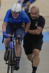 Italy's Simone Consonni is helped restart the race after crashing during the men's madison event, at the Summer Olympics, Saturday, Aug. 10, 2024, in Paris, France. (AP Photo/Ricardo Mazalan)