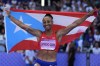 Jasmine Camacho-Quinn, of Puerto Rico, celebrates her third place finish in the women's 100-meter hurdles final at the 2024 Summer Olympics, Saturday, Aug. 10, 2024, in Saint-Denis, France. (AP Photo/Matthias Schrader)