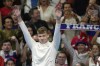 Leon Marchand of France, waves as he stands on the podium to receive his gold medal for the men's 200-meter individual medley final at the 2024 Summer Olympics, Friday, Aug. 2, 2024, in Nanterre, France. (AP Photo/Ashley Landis)