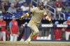 San Diego Padres' Luis Arraez follows through on a single to score Bryce Johnson during the eighth inning of a baseball game against the Miami Marlins, Saturday, Aug. 10, 2024, in Miami. (AP Photo/Lynne Sladky)