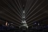 A light show is projected from the Eiffel Tower in Paris, France, during the opening ceremony of the 2024 Summer Olympics, Friday, July 26, 2024. (AP Photo/David J. Phillip)