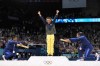 Silver medalist Simone Biles, of the United States, left, and bronze medalist Jordan Chiles, of the United States, right, bow to gold medalist Rebeca Andrade, of Brazil, during the medal ceremony for the women's artistic gymnastics individual floor finals at Bercy Arena at the 2024 Summer Olympics, Monday, Aug. 5, 2024, in Paris, France. (AP Photo/Abbie Parr)