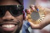 American Olympic champion Noah Lyles poses with this gold medal before an interview in Paris, France, Sunday, Aug. 11, 2024. (AP Photo/Aurelien Morissard)