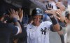 New York Yankees' Aaron Judge is greeted in the dugout after hitting a home run in the seventh inning of a baseball game against the Texas Rangers, Sunday, Aug. 11, 2024, in New York. (AP Photo/John Munson)