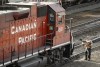 An employee boards a Canadian Pacific Railway locomotive at a yard in Calgary, Alta., Friday, March 18, 2022. The country's two main railways remain at loggerheads with their workers over scheduling, safety or salaries — depending on who you ask — as the clock ticks down on contract negotiations. THE CANADIAN PRESS/Jeff McIntosh