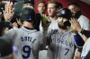 Colorado Rockies' Brenton Doyle (9) celebrates after scoring against the Arizona Diamondbacks on a sacrifice fly hit by Rockies' Brendan Rodgers (7) during the fourth inning of a baseball game, Monday, Aug. 12, 2024, in Phoenix. (AP Photo/Ross D. Franklin)