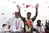 Men's javelin gold medalist, Arshad Nadeem of Pakistan, centre, waves to people outside his village in Mian Channu, Khanewal district, of Pakistan, Sunday, Aug. 11, 2024. (AP Photo/Asim Tanveer)