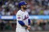 New York Mets' J.D. Martinez holds his hand after being hit by a pitch during the third inning of a baseball game against the Oakland Athletics, Tuesday, Aug. 13, 2024, in New York. (AP Photo/Julia Nikhinson)