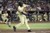 Arizona Diamondbacks' Josh Bell connects for a run-scoring double against the Colorado Rockies during the third inning of a baseball game, Tuesday, Aug. 13, 2024, in Phoenix. (AP Photo/Ross D. Franklin)