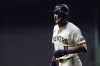 Milwaukee Brewers' Jackson Chourio smiles after hitting an RBI-single during the second inning of a baseball game against the Los Angeles Dodgers, Wednesday, Aug. 14, 2024, in Milwaukee. (AP Photo/Aaron Gash)