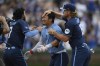 Chicago Cubs' Seiya Suzuki, center, celebrates with teammates Dansby Swanson, left, and Patrick Wisdom, right, after hitting a walkoff single to defeat the Toronto Blue Jays in 10 innings of a baseball game in Chicago, Friday, Aug. 16, 2024. (AP Photo/Paul Beaty)