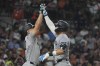 New York Yankees' Aaron Judge, right, is greeted by Giancarlo Stanton after a solo home run during the eighth inning of a baseball game against the Detroit Tigers, Friday, Aug. 16, 2024, in Detroit. (AP Photo/Carlos Osorio)