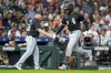 Chicago White Sox's Luis Robert Jr., right, celebrates after his two-run home run against the Houston Astros with third base coach Justin Jirschele, left, during the third inning of a baseball game Friday, Aug. 16, 2024, in Houston. (AP Photo/Eric Christian Smith)