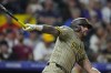 San Diego Padres' David Peralta grounds out in the ninth inning of a baseball game against the Colorado Rockies, Saturday, Aug. 17, 2024, in Denver. (AP Photo/David Zalubowski)