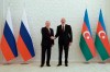 Russian President Vladimir Putin, left, and Azerbaijani President Ilham Aliyev, right, shake hands during their meeting at Zagulba state residence in Baku, Azerbaijan, Monday, Aug. 19, 2024. (Vyacheslav Prokofyev, Sputnik, Kremlin Pool Photo via AP)
