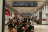 People wait inside at the Union Station bus terminal as a national rail shutdown causes delays, after employees were locked out by both major Canadian railways after a deadlock in contract negotiations, in Toronto, Thursday, Aug. 22, 2024. Thousands of Canadian commuters may have to change their travel plans for a second day after a countrywide rail lockout shut down lines in major metropolitan areas. THE CANADIAN PRESS/Paige Taylor White
