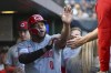 Cincinnati Reds infielder Dominic Smith celebrates after scoring against the Pittsburgh Pirates in the fourth inning of a baseball game, Saturday, Aug. 24, 2024, in Pittsburgh. (AP Photo/Barry Reeger)