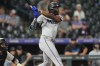Miami Marlins' Jesus Sanchez follows the flight of his three-run home run off Colorado Rockies relief pitcher Angel Chivilli in the ninth inning of after a baseball game, Tuesday, Aug. 27, 2024, in Denver. (AP Photo/David Zalubowski)