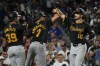 Pittsburgh Pirates' Bryan Reynolds, right, celebrates with Isiah Kiner-Falefa, center, and Nick Gonzales, left, after hitting a three-run home run during the eighth inning of a baseball game against the Chicago Cubs in Chicago, Monday, Sept. 2, 2024. (AP Photo/Nam Y. Huh)