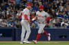 Philadelphia Phillies' Kyle Schwarber, right, celebrates hitting a solo home run in the fourth inning of a baseball game against the Toronto Blue Jays in Toronto on Tuesday Sept. 3, 2024. THE CANADIAN PRESS/Jon Blacker