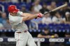 Philadelphia Phillies' J.T. Realmuto hits an RBI single to score Bryce Harper during the first inning of a baseball game against the Miami Marlins, Friday, Sept. 6, 2024, in Miami. (AP Photo/Lynne Sladky)