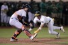 Oakland Athletics' Max Schuemann (12) slides into home plate past Detroit Tigers catcher Jake Rogers (34) to score a run on a sacrifice hit by Brent Rooker during the 12th inning of a baseball game Friday, Sept. 6, 2024, in Oakland, Calif. (AP Photo/Tony Avelar)