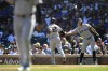 New York Yankees' Giancarlo Stanton, right, celebrates with teammate Gleyber Torres (25) after Torres scored on an Austin Wells ground out during the first inning of a baseball game against the Chicago Cubs in Chicago, Saturday, Sept. 7, 2024. (AP Photo/Paul Beaty)