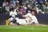 Milwaukee Brewers' Sal Frelick (10) scores on an RBI double hit by Joey Ortiz during the fourth inning of a baseball game against the Colorado Rockies, Saturday, Sept. 7, 2024, in Milwaukee. (AP Photo/Kayla Wolf)