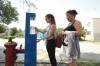 Ruth Bonneville / Free Press
                                Madison and her mom Priscilla stop to fill up a water bottle at one of eight hydration stations the city has installed in recent years. The stations are part of the city&rsquo;s response to extreme heat concerns.