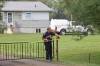 An RCMP officer adjusts the yellow tape Friday outside the rural home southeast of McCreary where police found the bodies of two men and a woman earlier in the day. (Tim Smith / The Brandon Sun files)