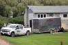 Colin Slark/The Brandon Sun
                                A truck and trailer from Parkland Cleaners and Restoration sat outside a house southwest of McCreary on Tuesday, four days after three homicide victims were found inside by the RCMP.
