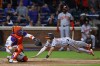 Baltimore Orioles first base Ryan Mountcastle (6) scores before New York Mets catcher Francisco Alvarez can make the tag on a single by Gunnar Henderson during the ninth inning of a baseball game, Tuesday, Aug. 20, 2024, in New York. (AP Photo/Rich Schultz)