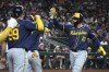 Milwaukee Brewers' Rhys Hoskins (12) celebrates with teammates after hitting a two-run home run against the Arizona Diamondbacks in the fourth inning during a baseball game, Friday, Sept. 13, 2024, in Phoenix. (AP Photo/Rick Scuteri)