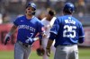 Kansas City Royals' Bobby Witt Jr. (7) rounds third to greetings from third base coach Vance Wilson (25) after hitting a solo home run off Pittsburgh Pirates starting pitcher Mitch Keller during the first inning of a baseball game in Pittsburgh, Saturday, Sept. 14, 2024. (AP Photo/Gene J. Puskar)