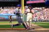 New York Mets' Mark Vientos, left, scores past Philadelphia Phillies' J.T. Realmuto, right, during the third inning of a baseball game, Saturday, Sept. 14, 2024, in Philadelphia. (AP Photo/Derik Hamilton)