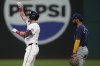 Cleveland Guardians' Lane Thomas, left, gestures from second base in front of Tampa Bay Rays second baseman Jose Caballero (7) after hitting a double in the sixth inning of a baseball game Saturday, Sept. 14, 2024, in Cleveland. (AP Photo/Sue Ogrocki)