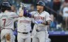 Arizona Diamondbacks' Corbin Carroll, left, congratulates Ketel Marte as he crosses home plate after hitting a two-run home run off Colorado Rockies starting pitcher Antonio Senzatela in the first inning of a baseball game, Monday, Sept. 16, 2024, in Denver. (AP Photo/David Zalubowski)