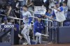Los Angeles Dodgers' Shohei Ohtani (17) waves to fans after he hit a home run scoring Andy Pages, during the seventh inning of a baseball game against the Miami Marlins, Thursday, Sept. 19, 2024, in Miami. (AP Photo/Wilfredo Lee)