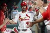 St. Louis Cardinals' Paul Goldschmidt, center, is congratulated by teammates after scoring during the fourth inning of a baseball game against the Pittsburgh Pirates, Thursday, Sept. 19, 2024, in St. Louis. (AP Photo/Scott Kane)