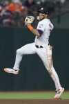 Houston Astros shortstop Jeremy Peña fields an infield single hit by Los Angeles Angels' Jordyn Adams during the fourth inning of a baseball game Thursday, Sept. 19, 2024, in Houston. (AP Photo/Kevin M. Cox)