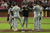 Pittsburgh Pirates manager Derek Shelton, center, hands the ball to pitcher Joey Wentz (34) during a pitching change in the fourth inning of a baseball against the Cincinnati Reds, Friday, Sept. 20, 2024, in Cincinnati. (AP Photo/Carolyn Kaster)