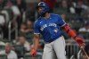 Toronto Blue Jays first base Vladimir Guerrero Jr. (27) hits a single in the sixxth inning of a baseball game against the Atlanta Braves Friday, Sept. 6, 2024, in Atlanta. (AP Photo/John Bazemore)