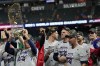 FILE - Atlanta Braves manager Brian Snitker holds up the trophy after winning baseball's World Series in Game 6 against the Houston Astros, Nov. 2, 2021, in Houston. (AP Photo/David J. Phillip, file)