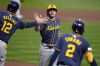 Milwaukee Brewers' Sal Frelick, center, is greeted by Rhys Hoskins (12) after both scored on a single by Joey Ortiz off Pittsburgh Pirates starting pitcher Bailey Falter during the second inning of a baseball game in Pittsburgh, Tuesday, Sept. 24, 2024. (AP Photo/Gene J. Puskar)