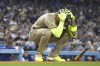 San Diego Padres' Manny Machado reacts after striking out during the fourth inning of a baseball game against the Los Angeles Dodgers, Tuesday, Sept. 24, 2024, in Los Angeles. (AP Photo/Mark J. Terrill)